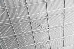 A sleek modern ceiling design with geometric patterns and steel framework.